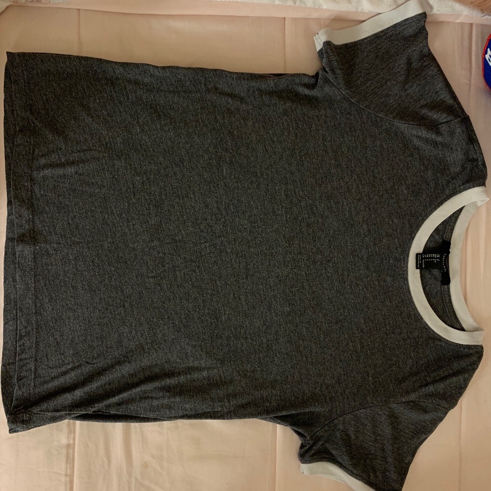 grey crew neck shirt.